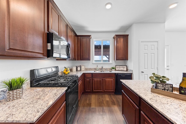 kitchen with black appliances, light stone countertops, dark hardwood / wood-style flooring, and sink