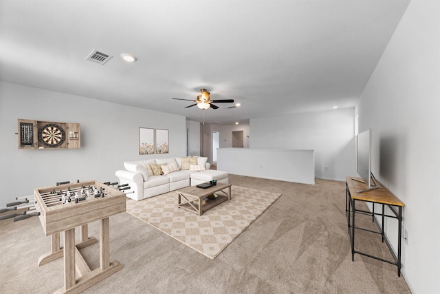 living room with ceiling fan and light colored carpet