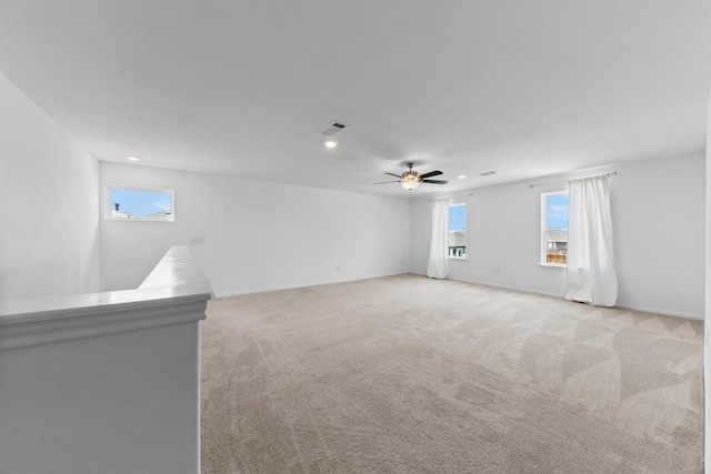 carpeted spare room with ceiling fan