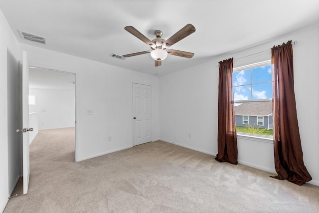 unfurnished bedroom with ceiling fan and light colored carpet