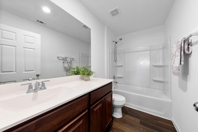 full bathroom with toilet, hardwood / wood-style floors, shower / washtub combination, and vanity