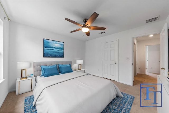 bedroom with ceiling fan and light colored carpet