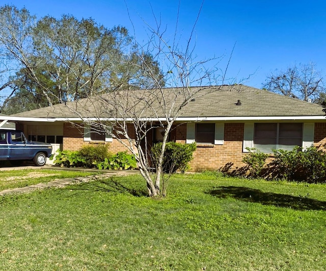 ranch-style home with a front yard and a carport