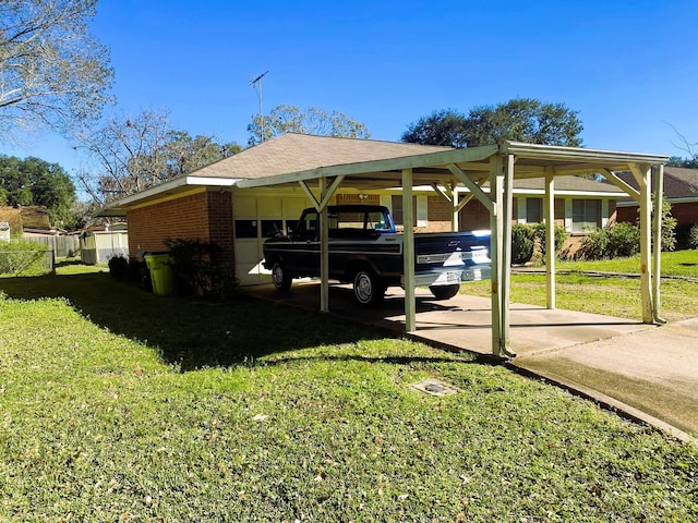 view of parking with a carport and a yard