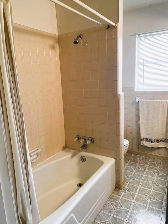 bathroom featuring tile walls, toilet, shower / tub combo, and tile patterned flooring