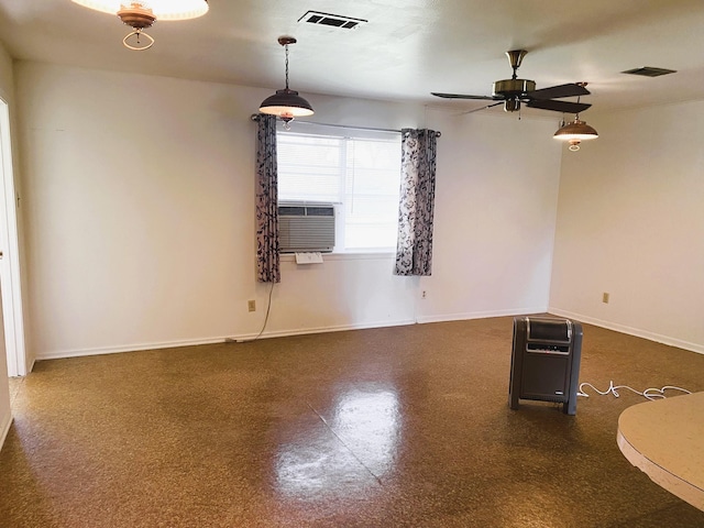 empty room featuring ceiling fan and cooling unit