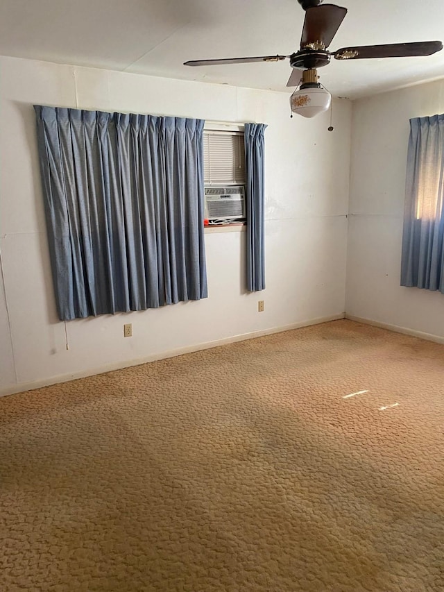 carpeted empty room featuring ceiling fan and cooling unit