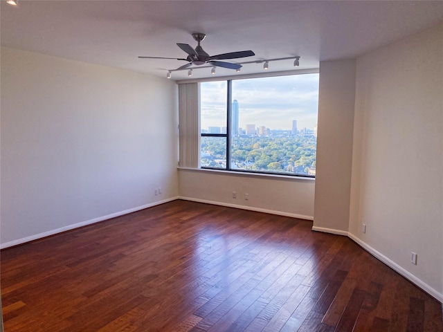 unfurnished room featuring ceiling fan and dark hardwood / wood-style flooring