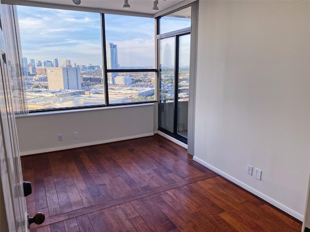 empty room with dark hardwood / wood-style flooring