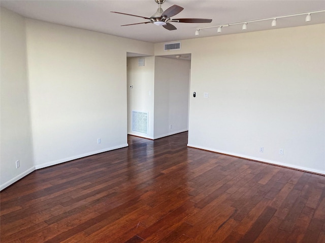 spare room with ceiling fan and dark hardwood / wood-style flooring