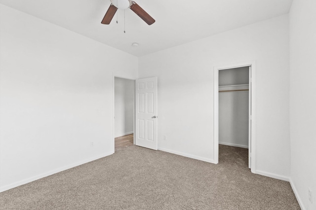 unfurnished bedroom featuring ceiling fan, carpet, and a closet