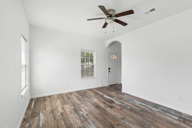 empty room featuring ceiling fan and dark hardwood / wood-style flooring