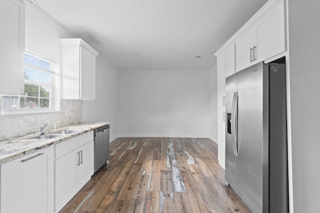 kitchen with white cabinets, appliances with stainless steel finishes, and sink