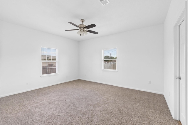 unfurnished room with ceiling fan and carpet flooring