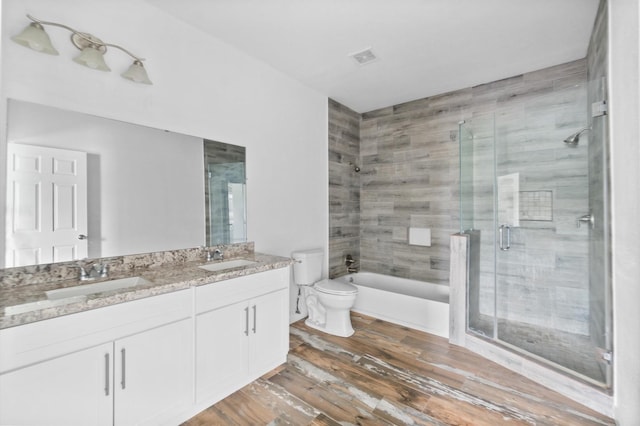 bathroom featuring hardwood / wood-style flooring, toilet, and vanity