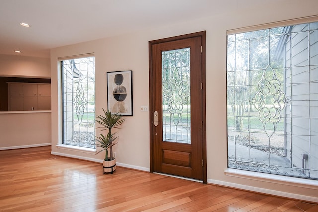 entrance foyer with light hardwood / wood-style flooring and a chandelier