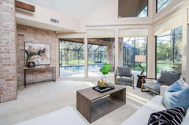 living room featuring a high ceiling and light colored carpet