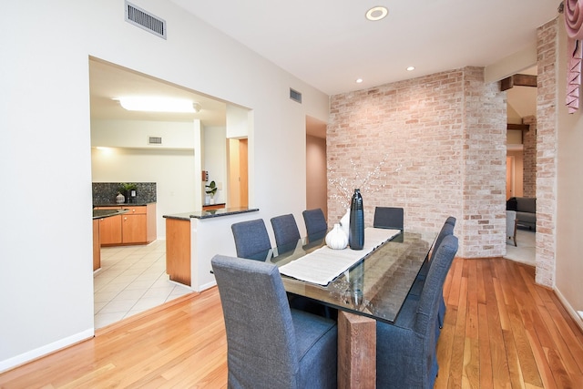 dining space with light hardwood / wood-style flooring