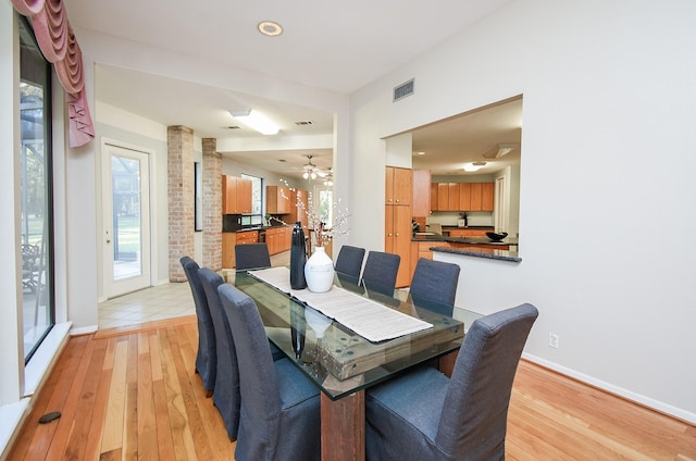 dining space with light wood-type flooring and ceiling fan