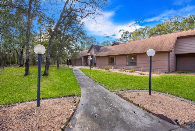 ranch-style home with a front lawn