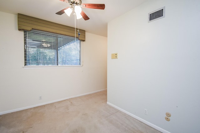 carpeted spare room featuring ceiling fan