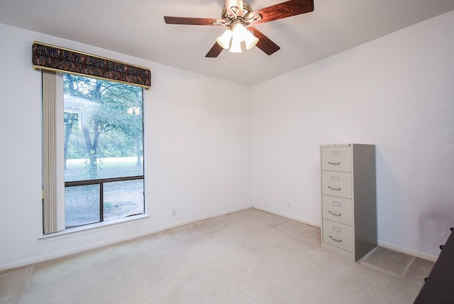 unfurnished room with ceiling fan and light colored carpet