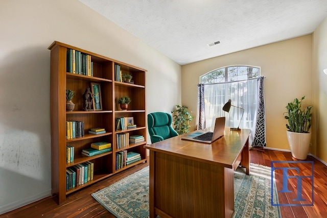 office space featuring dark wood-type flooring and a textured ceiling