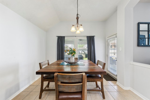 dining room featuring vaulted ceiling, an inviting chandelier, and light tile patterned flooring