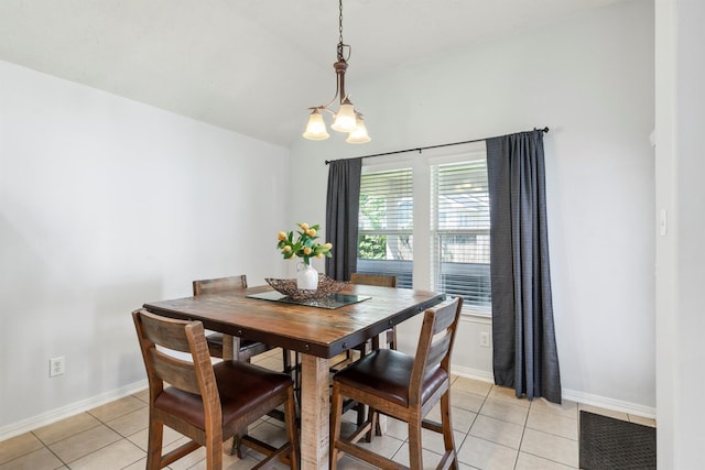 tiled dining room featuring a chandelier