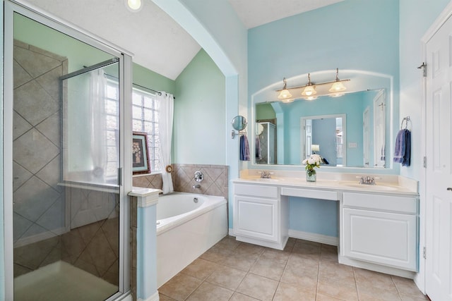 bathroom with vanity, lofted ceiling, independent shower and bath, and tile patterned flooring