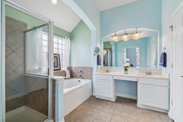 16407 Jadestone Terrace Ln, Houston, TX 77044 - full bath featuring tile patterned floors, a stall shower, vaulted ceiling, a bath, and double vanity