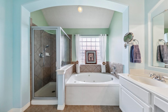 bathroom featuring tile patterned flooring, lofted ceiling, separate shower and tub, and vanity