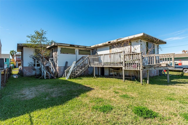 rear view of house featuring a wooden deck and a lawn