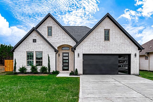 french country inspired facade with a front lawn