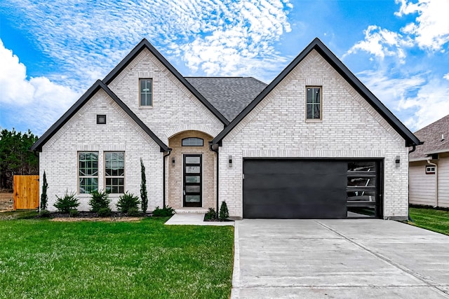 french provincial home with a front yard