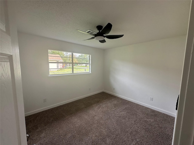 carpeted spare room with a textured ceiling and ceiling fan