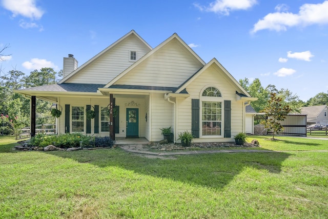 view of front of property with covered porch and a front yard