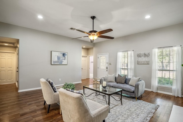 living room with ceiling fan and dark hardwood / wood-style flooring