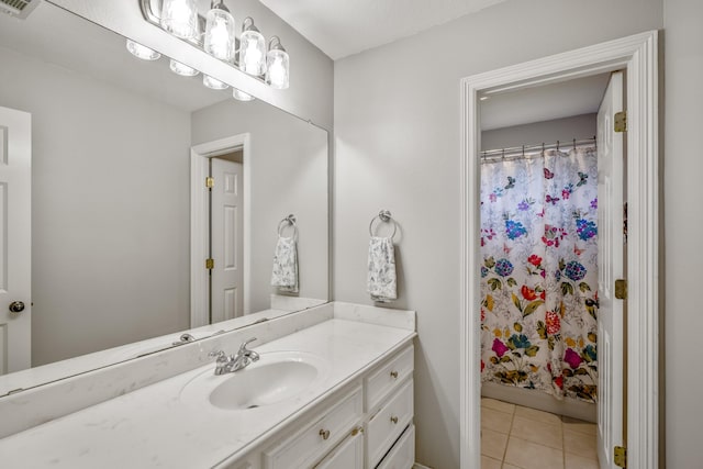 bathroom with tile patterned floors, vanity, and curtained shower