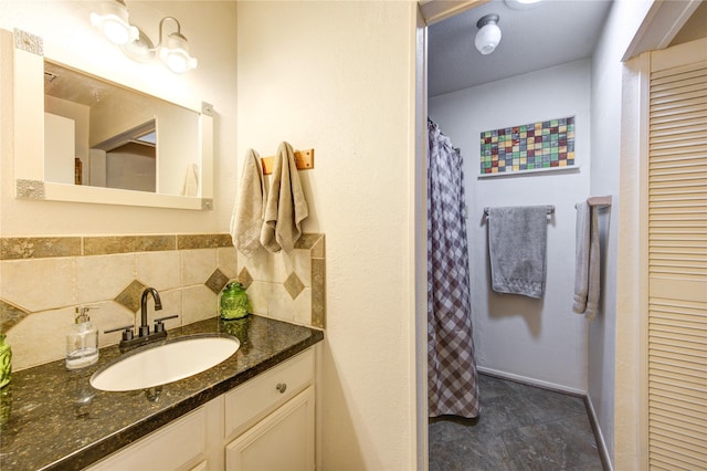 bathroom with vanity and tasteful backsplash