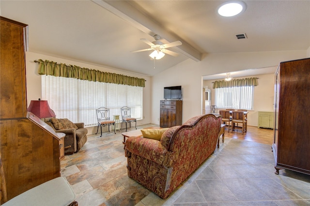 living room featuring ceiling fan and lofted ceiling with beams