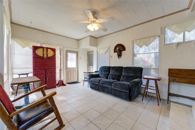 tiled living room featuring ceiling fan and crown molding