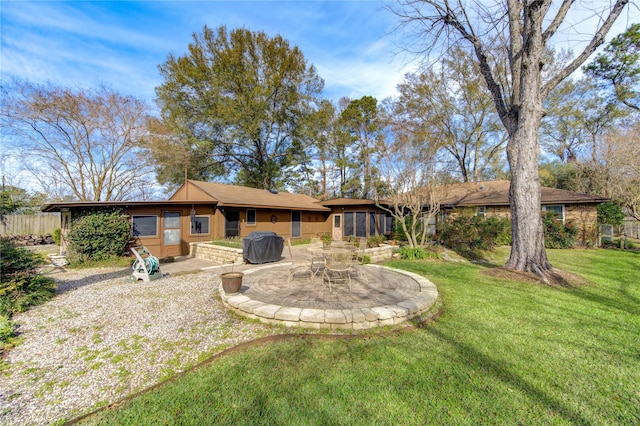 rear view of house with a yard and a patio