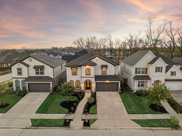 view of front of house featuring a yard and a garage