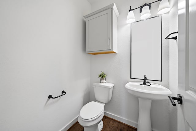 bathroom with hardwood / wood-style floors and toilet