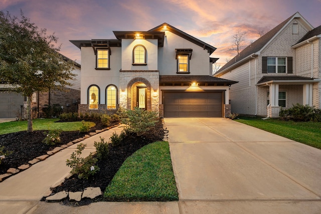 view of front of home with a garage and a yard