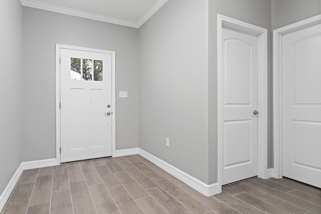 entryway with crown molding and light hardwood / wood-style flooring