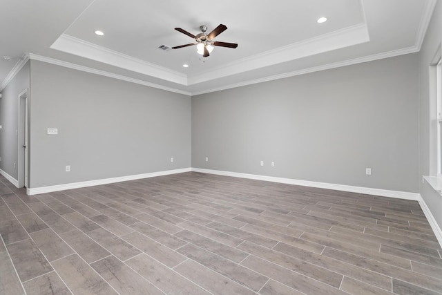 unfurnished room featuring ceiling fan, crown molding, and a raised ceiling