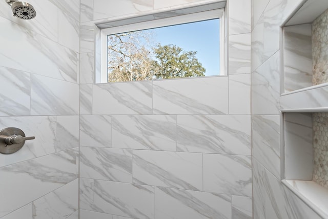 bathroom with tiled shower