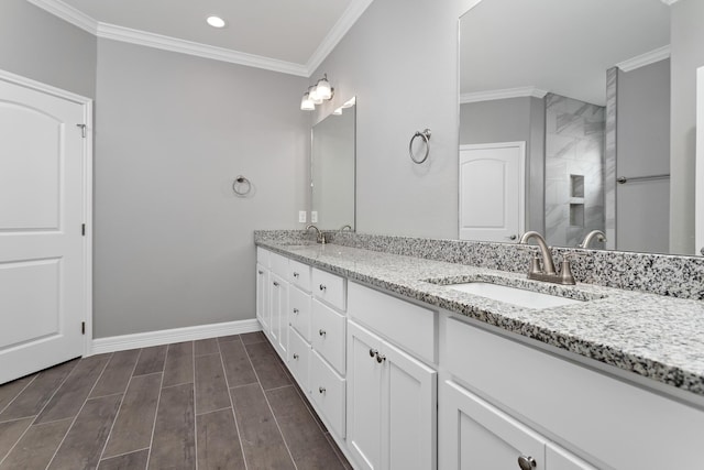 bathroom with a shower with shower door, vanity, and crown molding